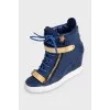 Leather wedge sneakers with embossed detailing