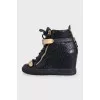 Black leather sneakers with gold hardware