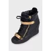 Black leather sneakers with gold hardware
