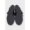 Black leather sneakers with gold hardware