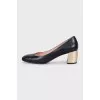 Black leather shoes with gold heels