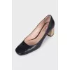 Black leather shoes with gold heels