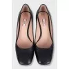 Black leather shoes with gold heels