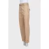 Tapered beige trousers with a belt