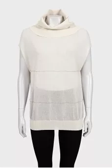 Beige sleeveless turtleneck decorated with rhinestones