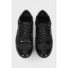 Black sneakers with varnish inserts