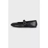 Black leather ballet flats with signature embroidery