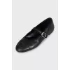 Black leather ballet flats with signature embroidery