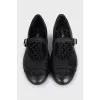 Black leather ballet flats with signature embroidery