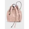 Pink leather bag decorated with perforations