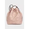 Pink leather bag decorated with perforations