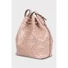 Pink leather bag decorated with perforations