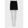 A suit consisting of a long jacket and a miniskirt