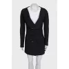 A suit consisting of a long jacket and a miniskirt