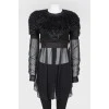 Black top with a decorative pile with a transparent bottom