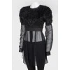 Black top with a decorative pile with a transparent bottom