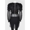 Black top with a decorative pile with a transparent bottom