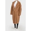 Brown coat of camel wool on buttons