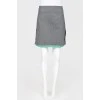 Gray woolen skirt on a green lining