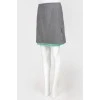 Gray woolen skirt on a green lining