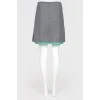 Gray woolen skirt on a green lining
