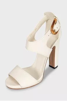 White leather sandals with a shaped buckle