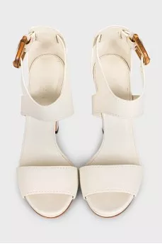 White leather sandals with a shaped buckle
