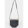 Leather curly bag with a metal handle
