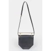 Leather curly bag with a metal handle