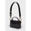 Little leather black handbag with tag