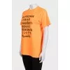 Bright orange T-shirt with a signature print