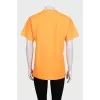 Bright orange T-shirt with a signature print