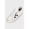 White leather sneakers with black heels