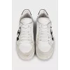 White leather sneakers with black heels