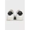 White leather sneakers with black heels