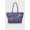 Wide leather bag of indigo color