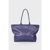 Wide leather bag of indigo color