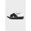 Black and white textile slip-ons