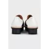 Black and white textile slip-ons
