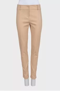 Beige tapered trousers with creases at the front