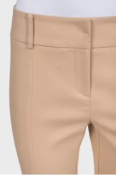 Beige tapered trousers with creases at the front