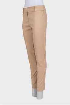 Beige tapered trousers with creases at the front