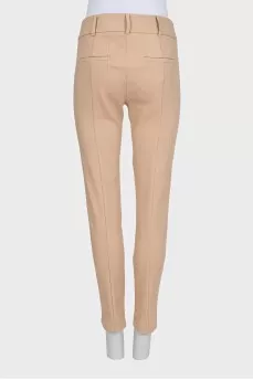 Beige tapered trousers with creases at the front