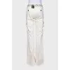 Flared trousers decorated with eyelets