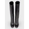 Black leather heeled boots with a wide boot