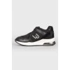 Black leather sneakers with lace and white soles
