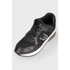 Black leather sneakers with lace and white soles