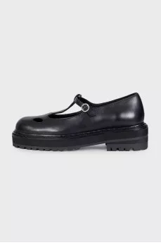 Black leather shoes with cutouts