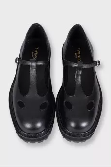 Black leather shoes with cutouts