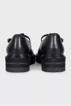 Black leather shoes with cutouts